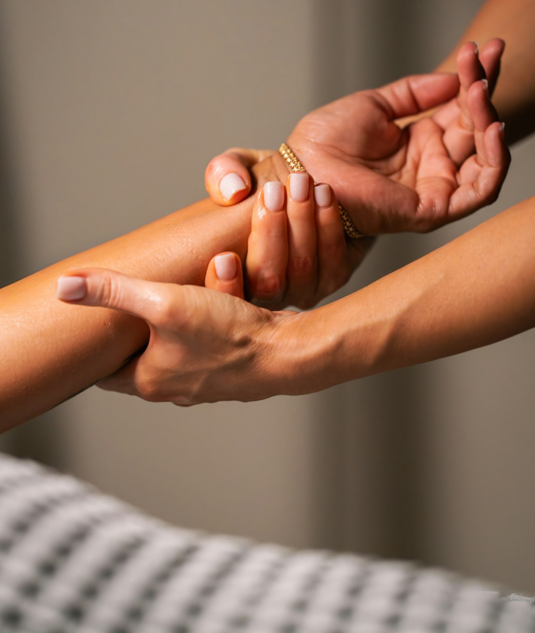 Therapist's hands working along a client's forearm